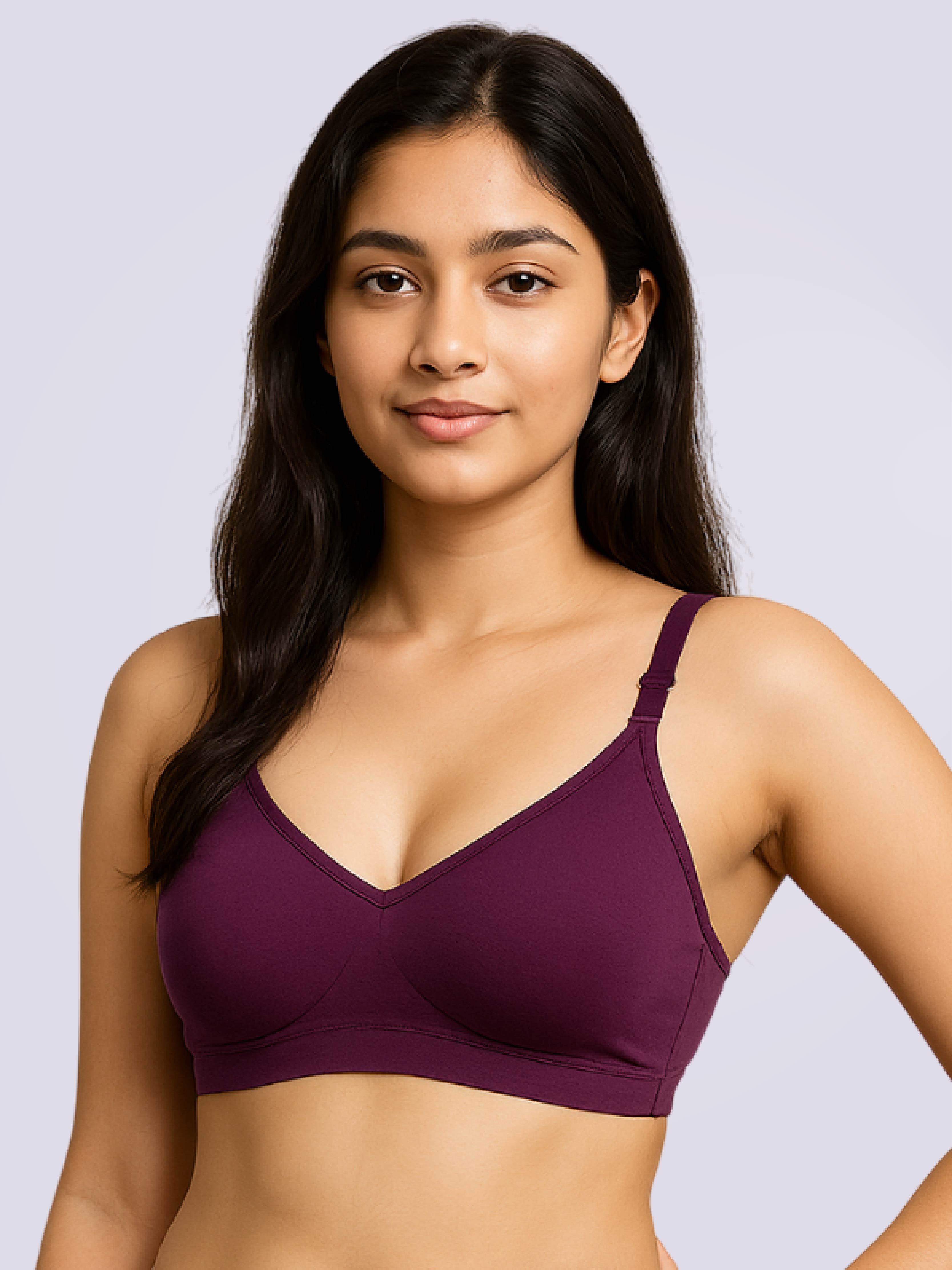 Woman wearing a purple bralette against a light gray background